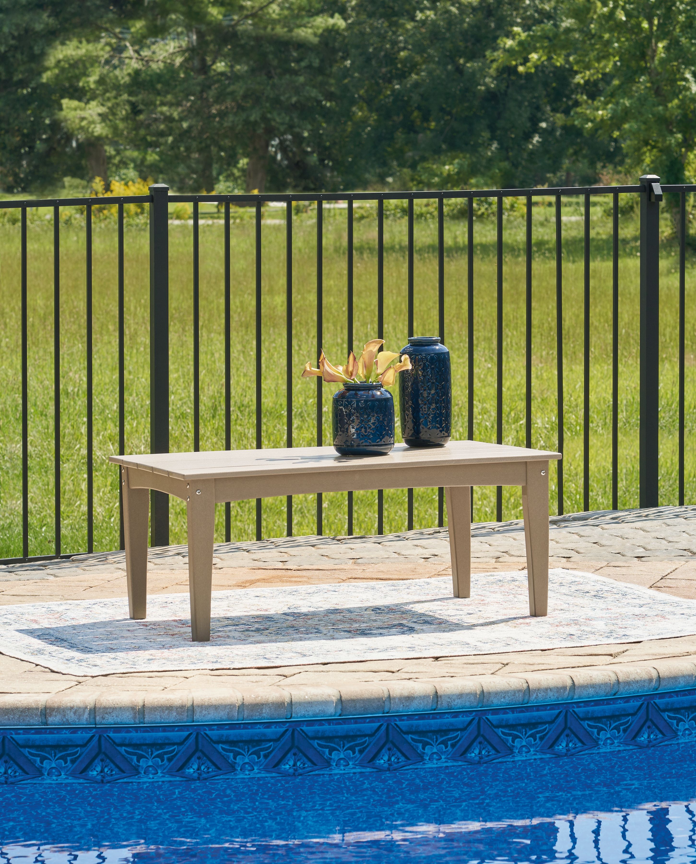 White rectangular cocktail table with four legs and decorative items on top