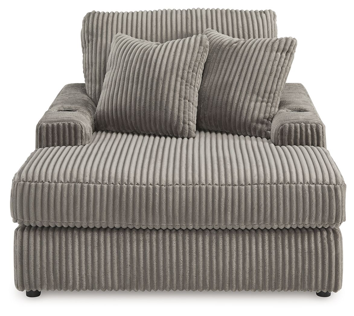 Corduroy chaise lounge chair in medium gray with three front cushions and two pillows.