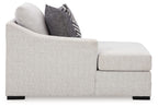 Stone gray chaise arm and seat cushion with dark patterned throw pillow