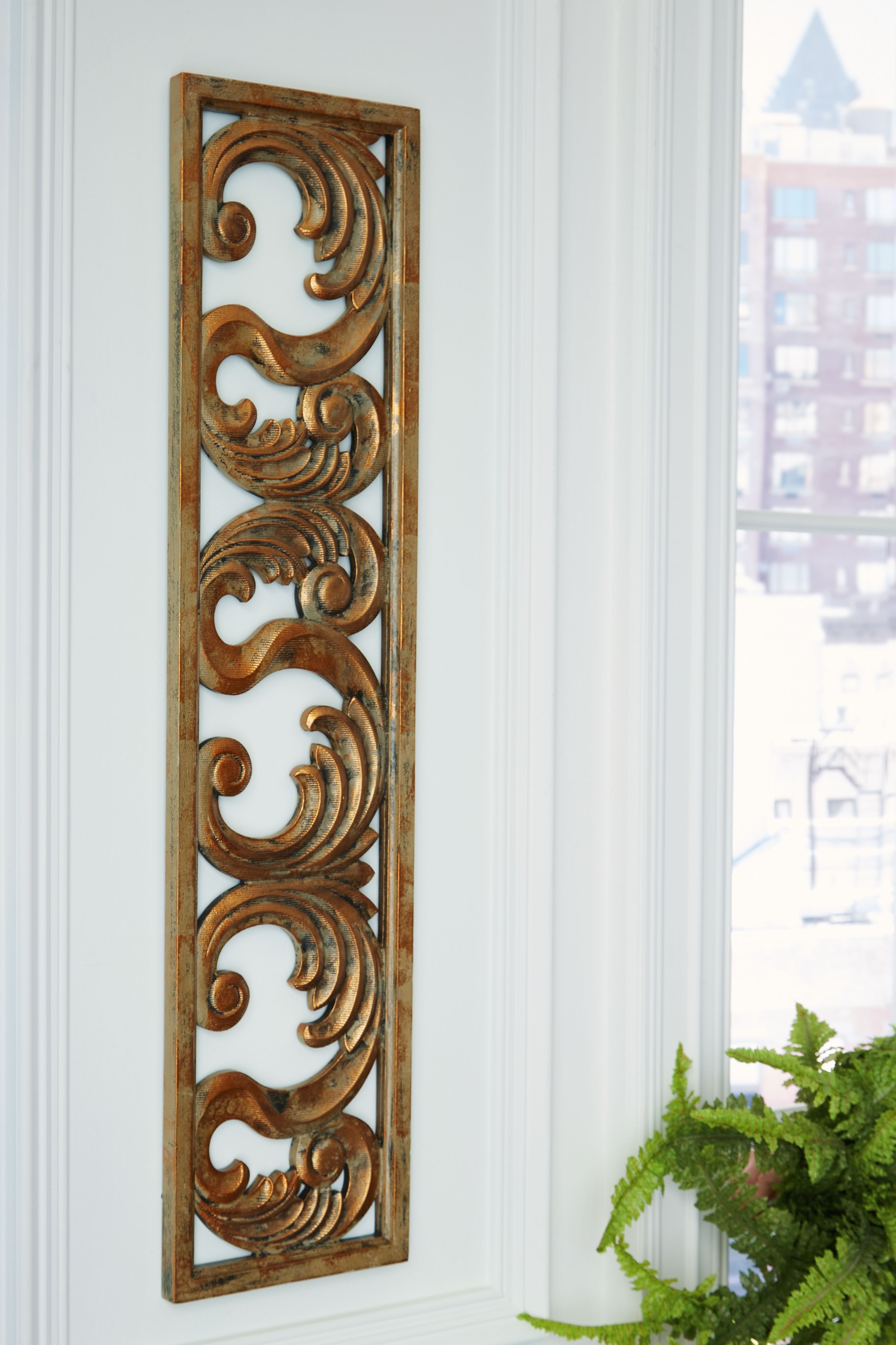 Carved wood wall decor panel with swirling scrollwork, dark natural finish.