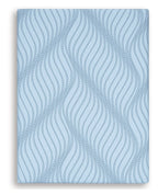 Blue memory foam mattress with wavy pattern cover, close-up