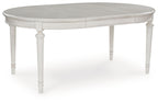 Antique white oval dining extension table with curved top and turned legs