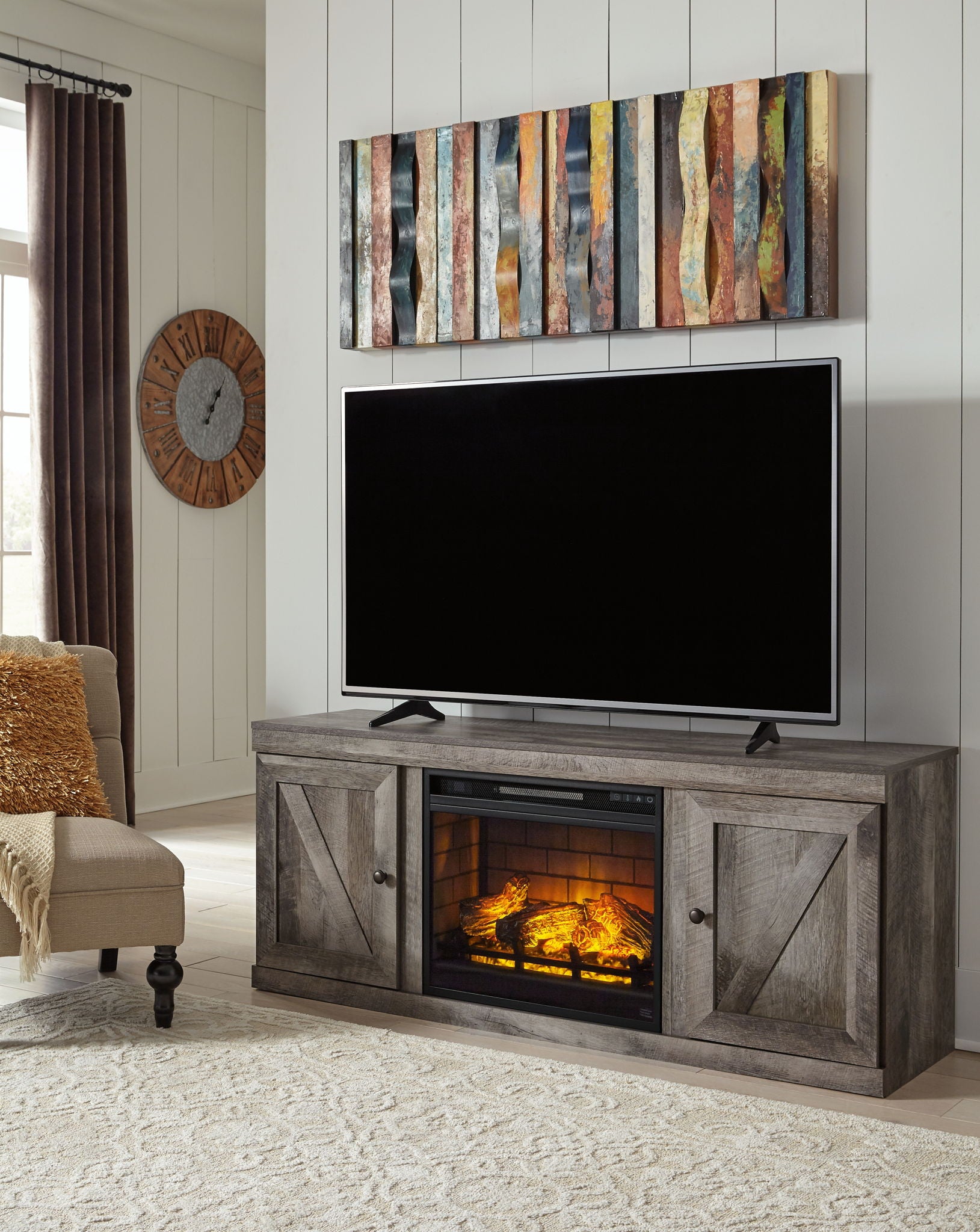 Gray TV stand with faux fireplace insert and flat-screen TV, open firebox
