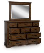 Medium brown dresser with mirror, stacked drawers and black pull handles