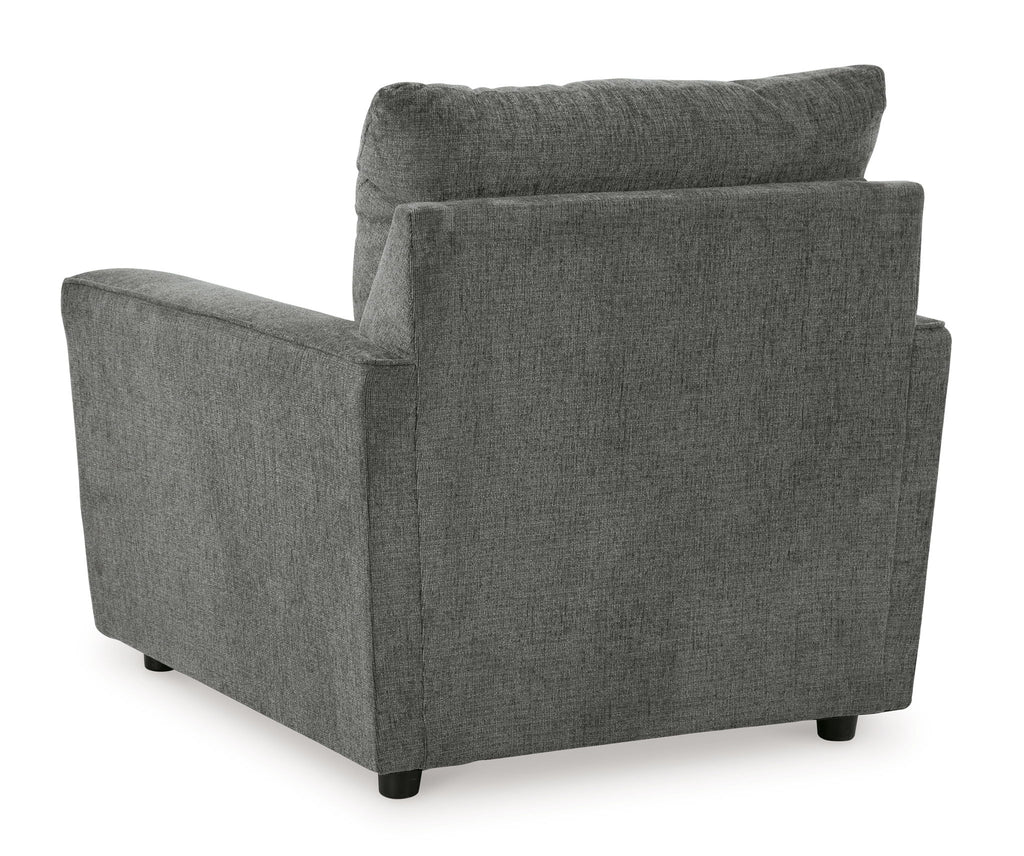 Dark gray upholstered armchair with thick backrest and block arms.