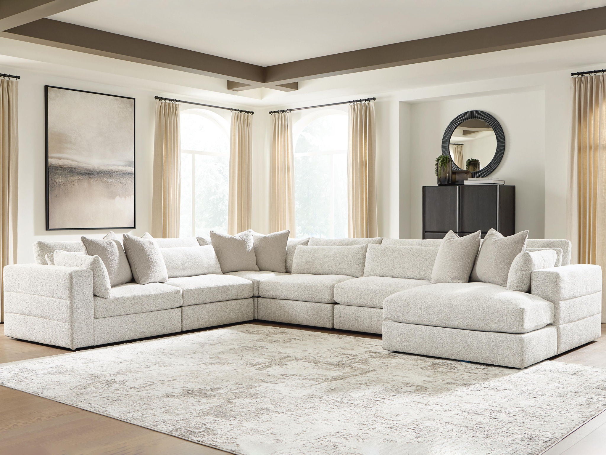 Beige sectional sofa with corner chaise and stacked throw pillows