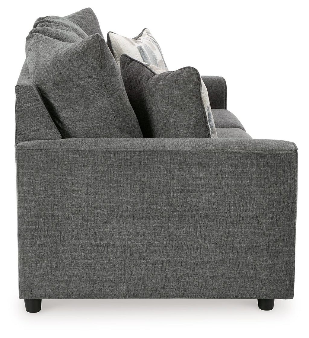 Dark gray fabric sofa with raised back and layered throw pillows.