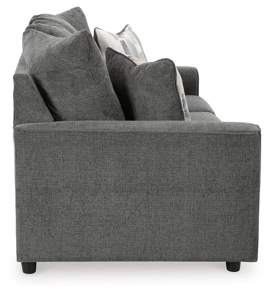 Dark gray fabric sofa with raised back and layered throw pillows.
