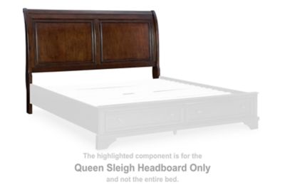 Brown wooden queen sleigh headboard with curved top and inset panels