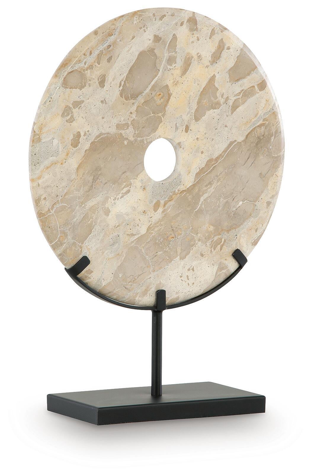 Light beige circular sculpture with drilled hole on dark metal stand base