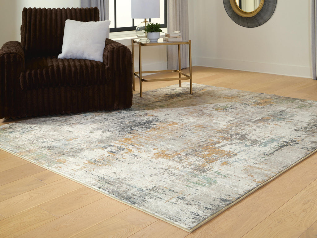 Abstract area rug with distressed motif and light cream, muted blue-gray coloring