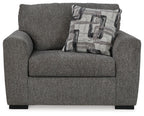 Gray chair and a half with patterned lumbar pillow, rolled arms, and thick padded seat