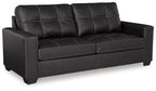 Black leather-look sofa with tufted back cushions and wide track arms