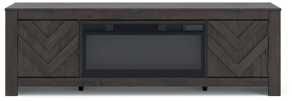 Dark TV stand with chevron cabinet doors and central TV opening, unlit fireplace