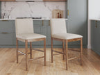 Pair of upholstered barstools with light beige seats, wood frames, metal footrest
