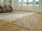 Light brown patterned area rug with distressed floral damask design