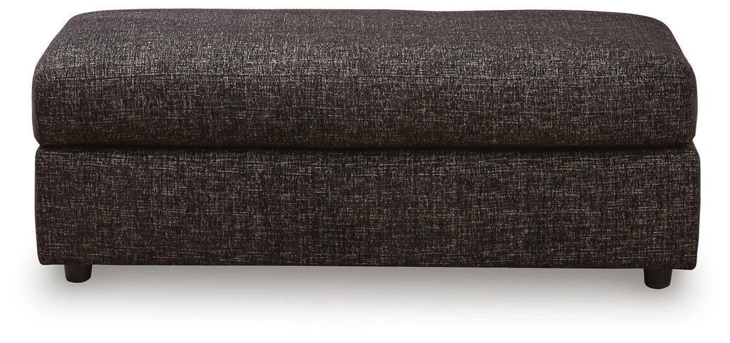 Oversized accent ottoman, dark textured fabric, rectangular top and low legs