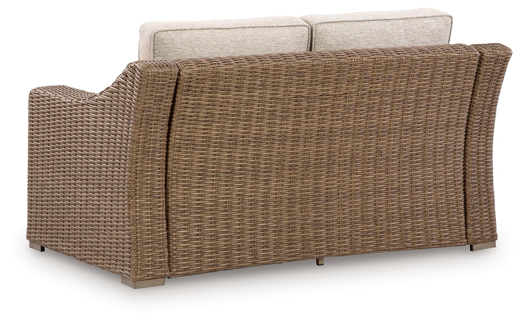 Beige loveseat seat cushion on brown woven wicker frame, side view