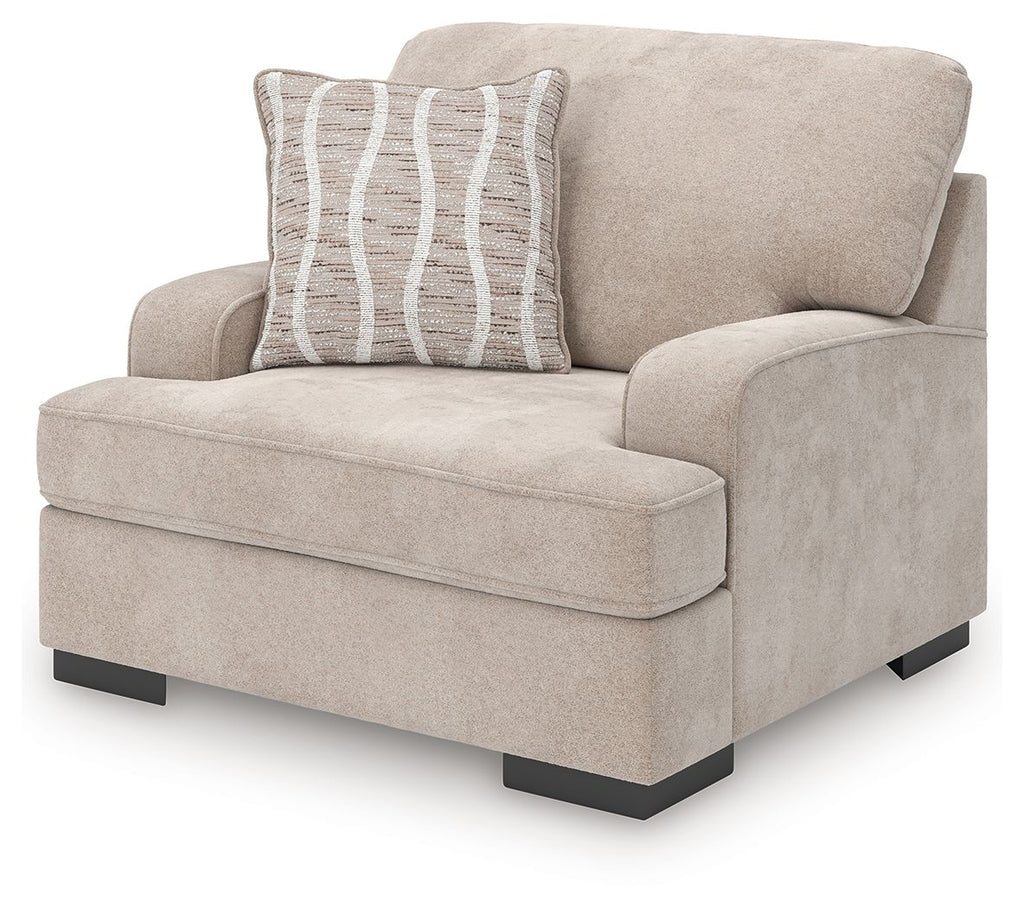 Taupe upholstered chair and a half with striped accent pillow, squared arms, dark legs