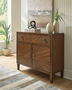 Medium brown accent cabinet with drawer and two cabinet doors, round metal handles