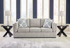 Gray living room sofa set with two patterned throw pillows and matching armchair ottoman