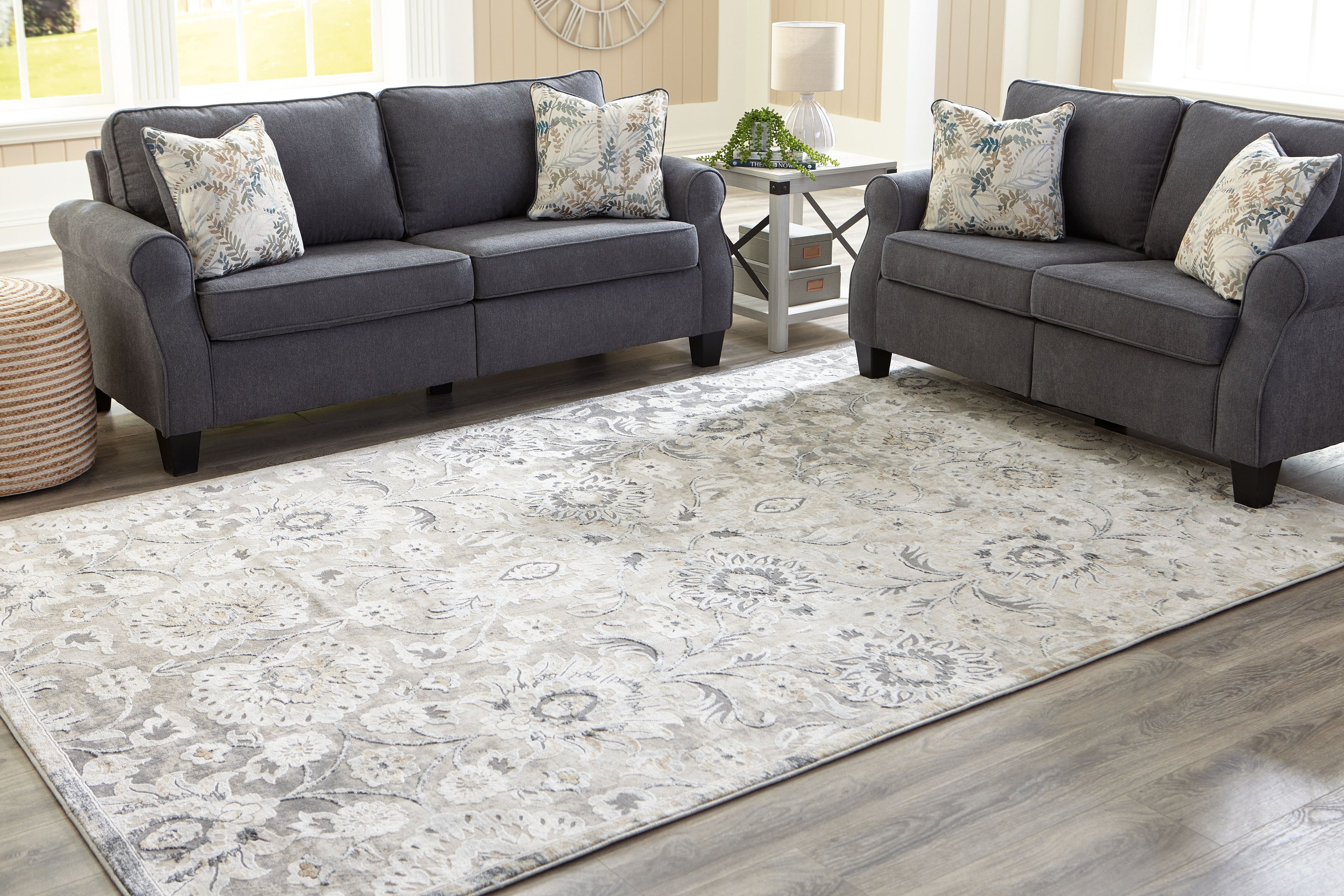 Large gray and cream ornate area rug with repeating floral motif
