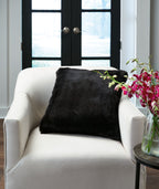 Black faux fur pillow, square with plush shag texture.