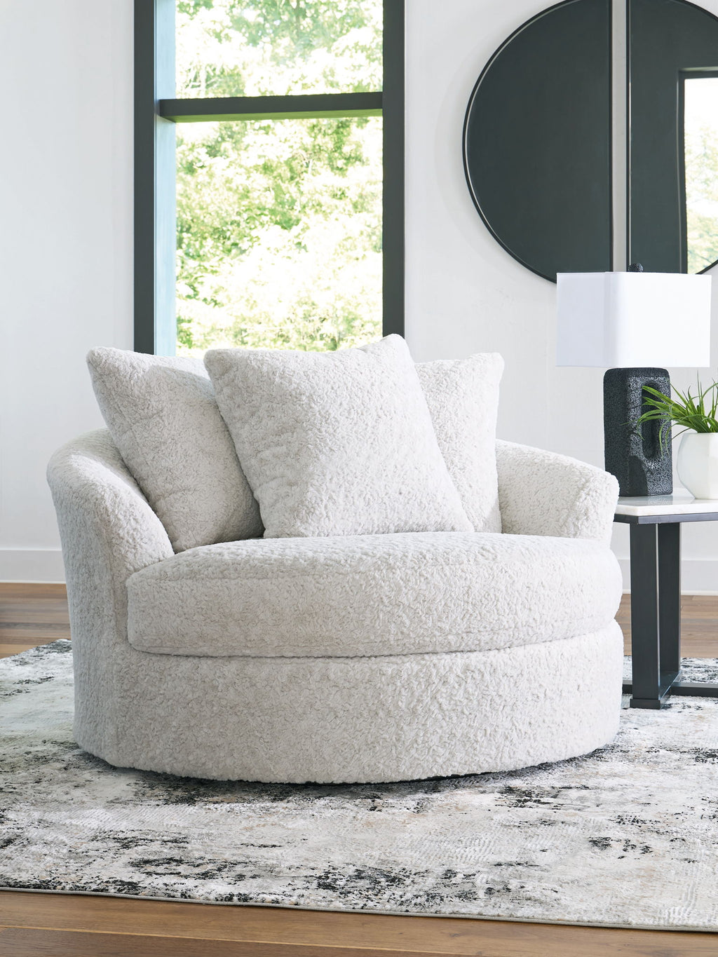 Swivel accent chair in light beige boucle fabric, with seat and back cushions.