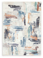 Washable rug with abstract beige base and blue, rust, and charcoal brushwork