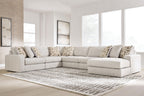 Light beige sectional sofa with corner chaise and patterned throw pillows.