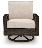 Swivel lounge chair with dark brown woven wicker frame and light beige padded back and seat