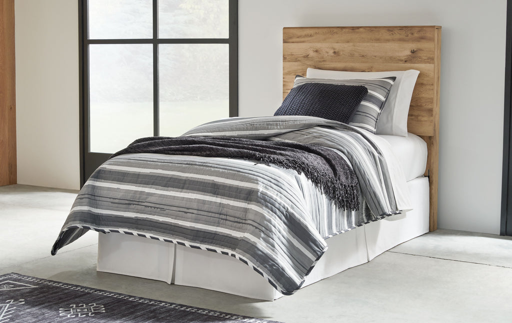 Beige wood panel headboard behind striped bedding and pillows