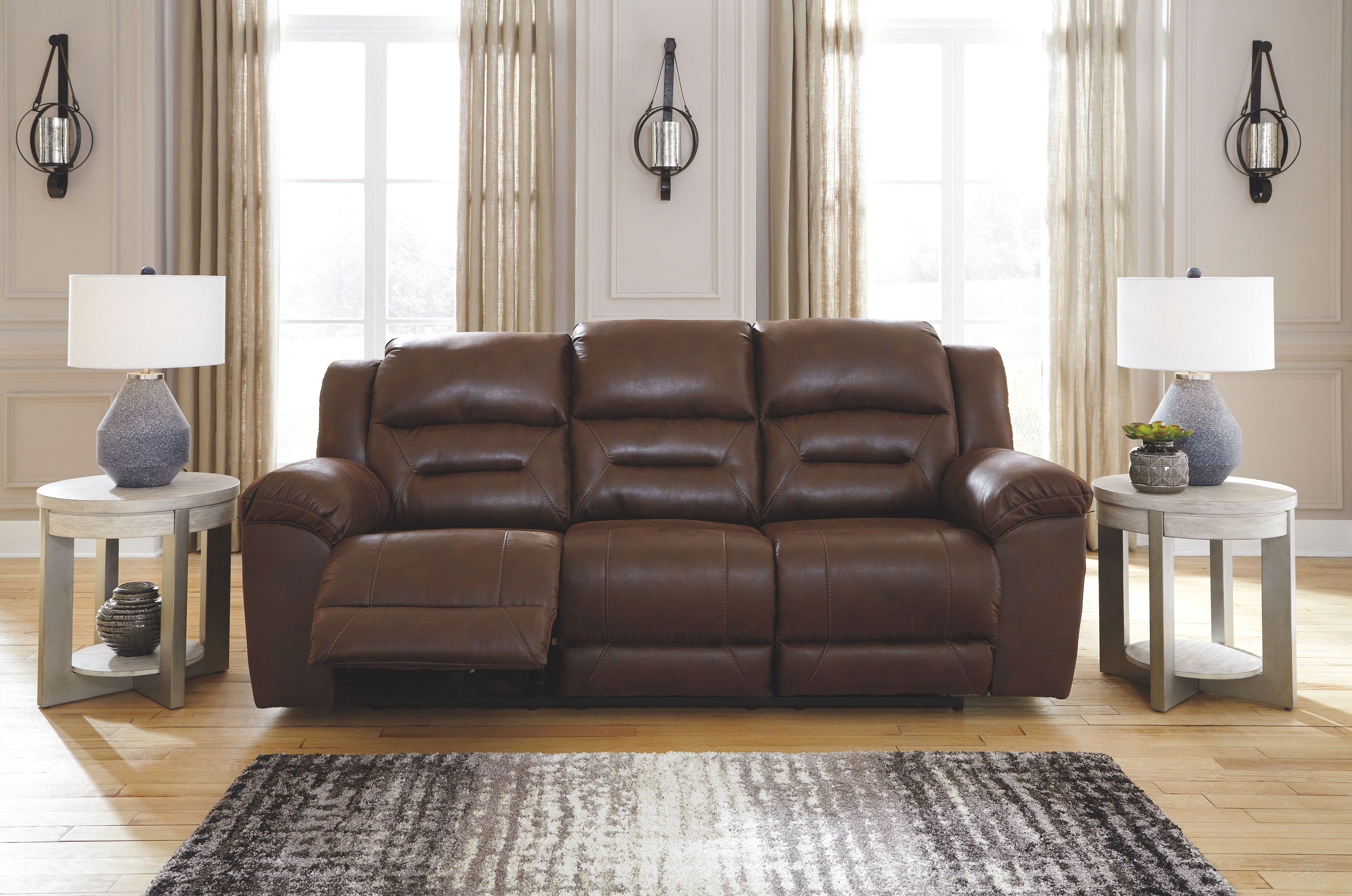 Brown reclining sofa set with padded headrests and plush armrests