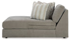 Ash gray corner chaise with tufted seat and striped and textured throw pillows