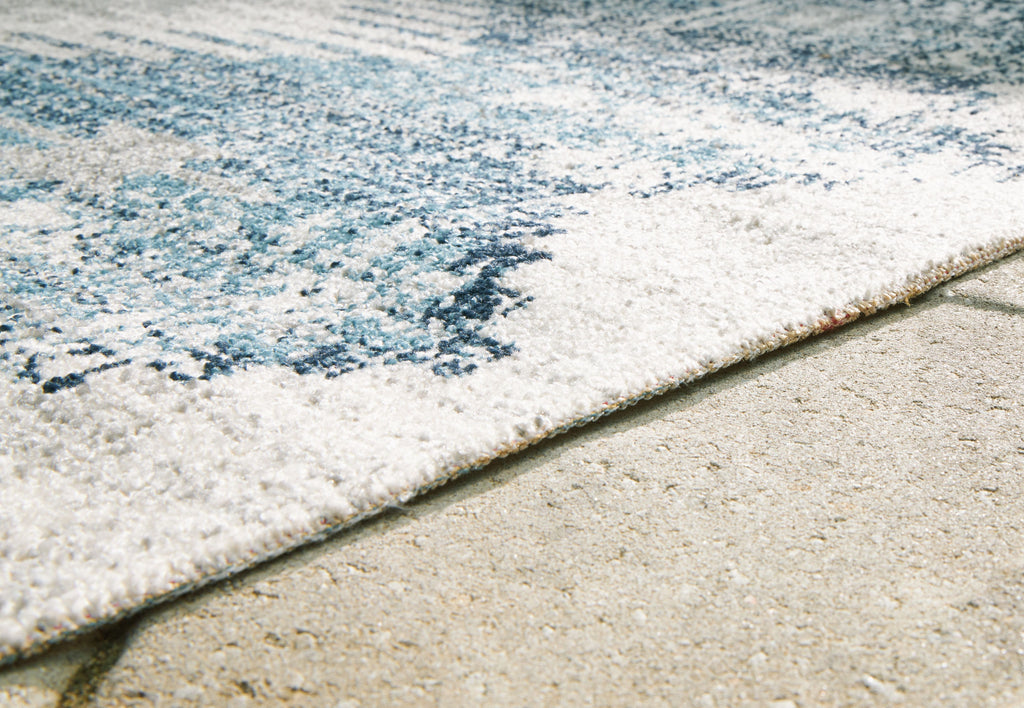 Blue and ivory area rug corner closeup with textured short pile