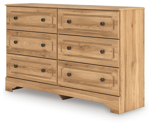 Aleaport dresser with light brown wood, eight drawers, and round black knobs