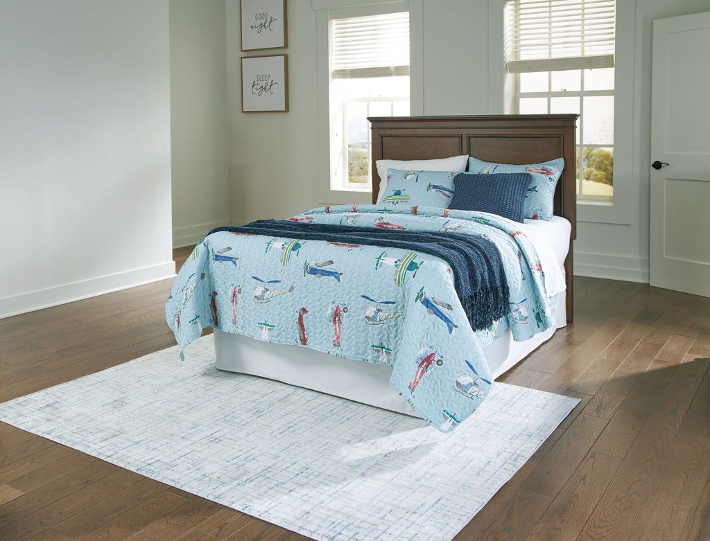 Brown full panel headboard with bed and white bedding in a bedroom