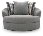 Gray oversized swivel accent chair with central back cushion and striped side pillows