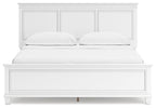 White panel bed front view with two cushions and paneled headboard behind.