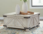 Whitewash cocktail table with storage, dark corner hardware and flat lift-top surface