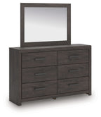 Charcoal dresser with six drawers and rectangular mirror, dark wood finish.