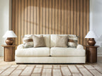 Light beige fabric sofa with three seat cushions and four back pillows