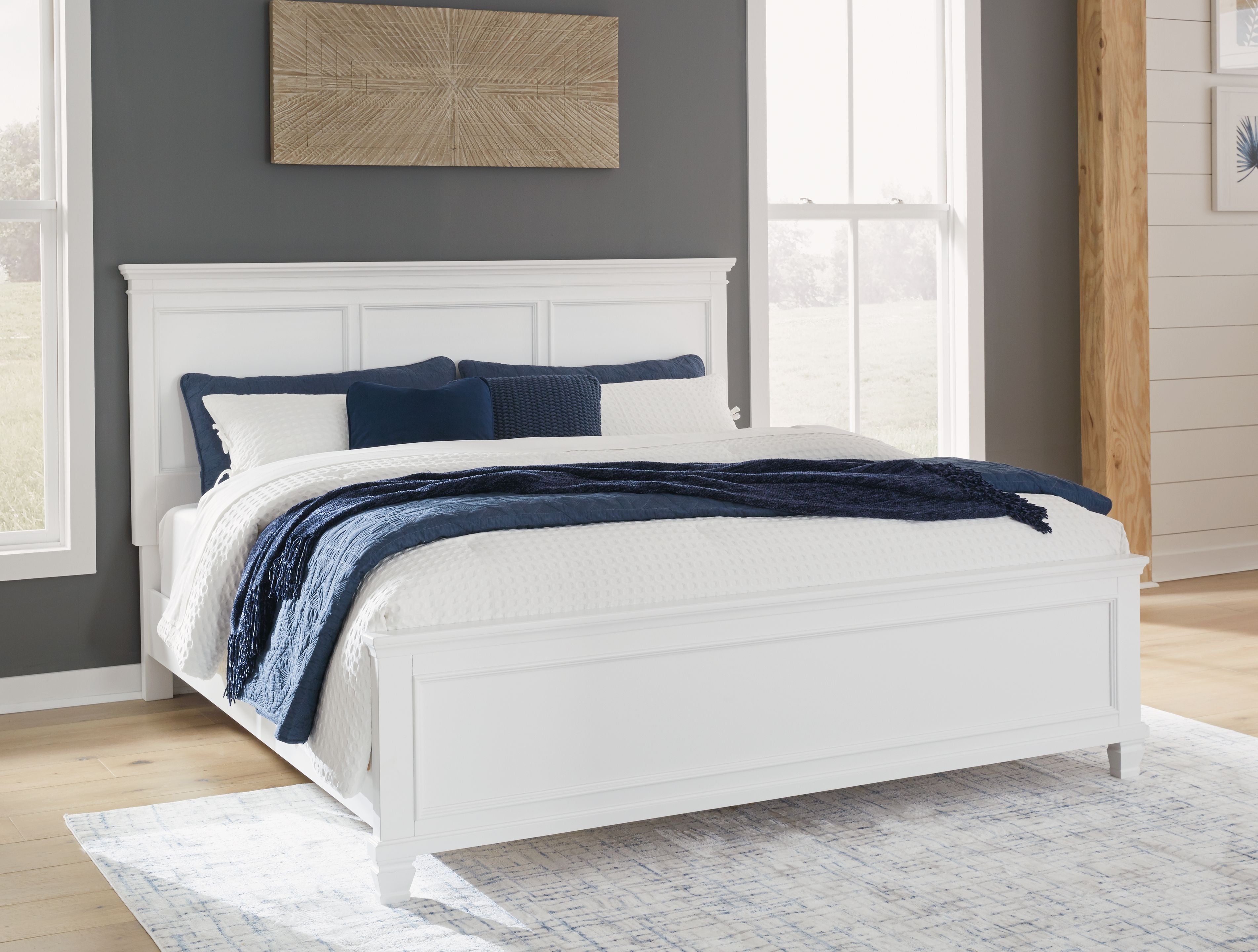 White panel bed frame with paneled headboard and low rails, styled with bedding