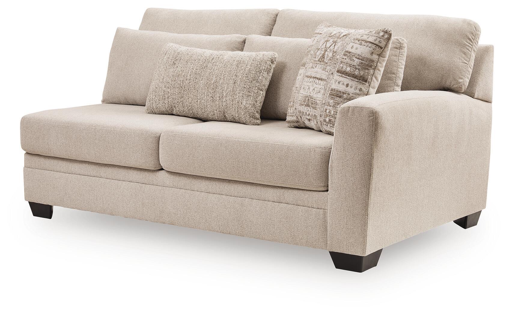 Beige fabric loveseat with square arms, two-tone pillows, and three seat cushions.