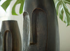 Bronze textured vase with vertical arched cutout, close-up side view