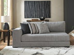 Gray fabric corner chaise with striped and solid accent pillows