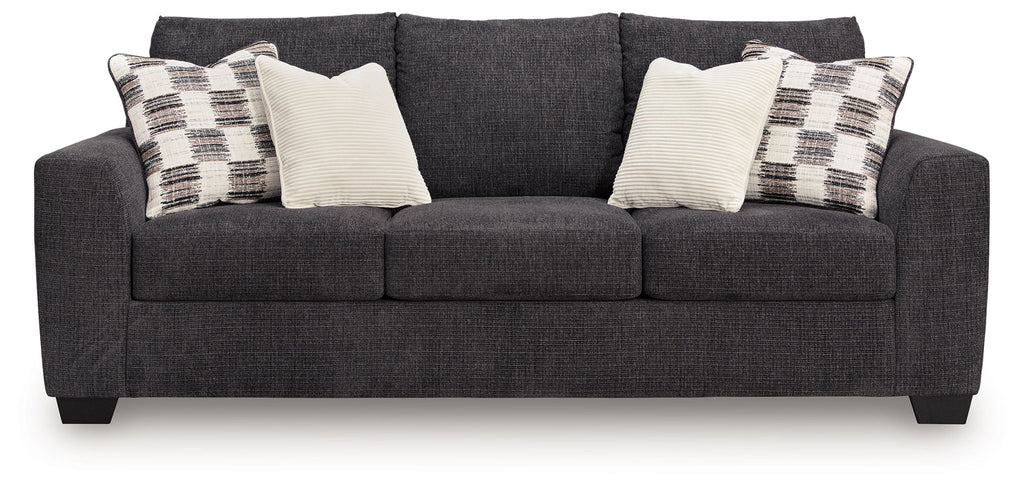 Dark gray sofa sleeper with three seat cushions and throw pillows