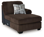 Chocolate brown corduroy corner chaise with thick seat, rounded arm, and patterned throw pillow