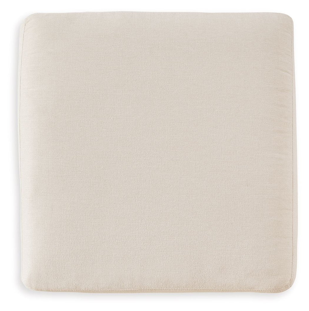 Cream upholstered accent ottoman with square seat and smooth fabric sides