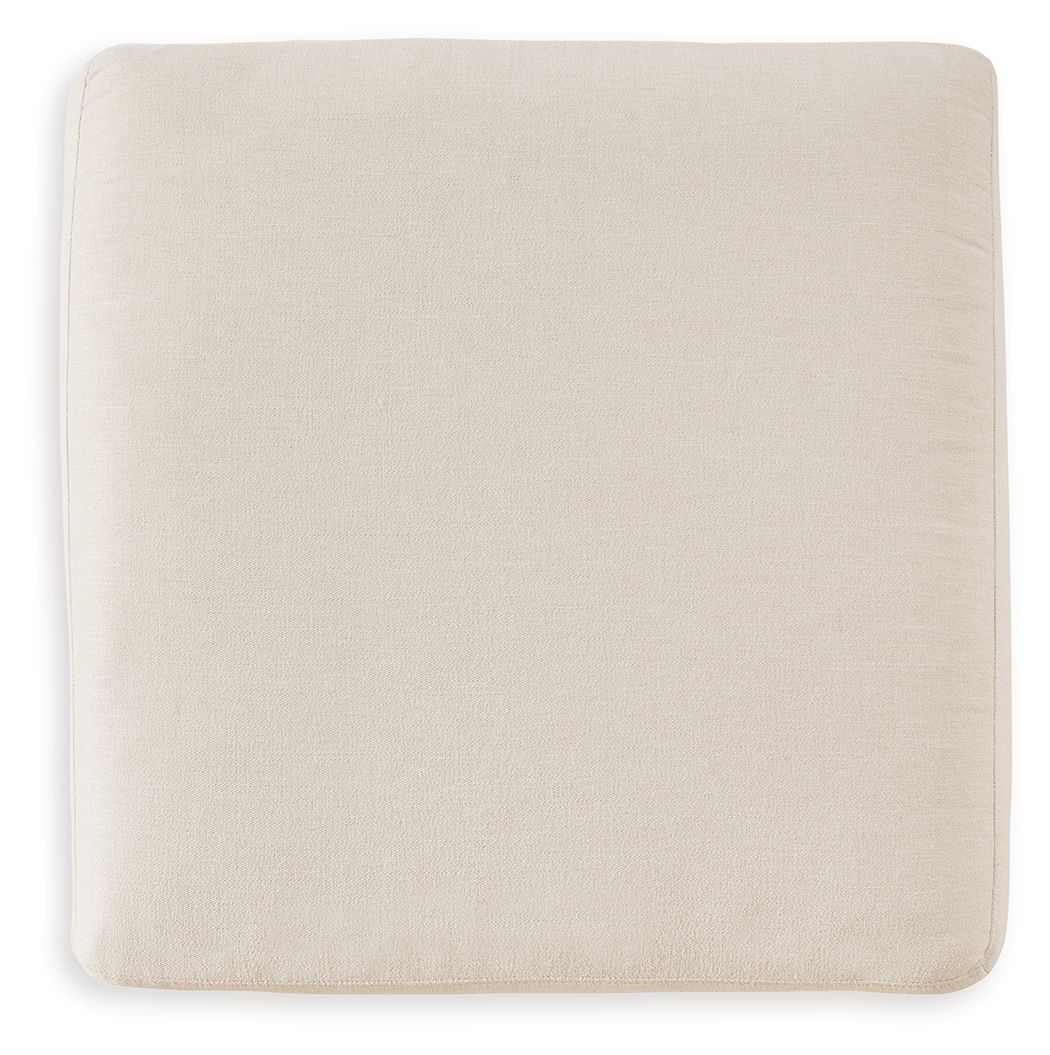 Cream upholstered accent ottoman with square seat and smooth fabric sides